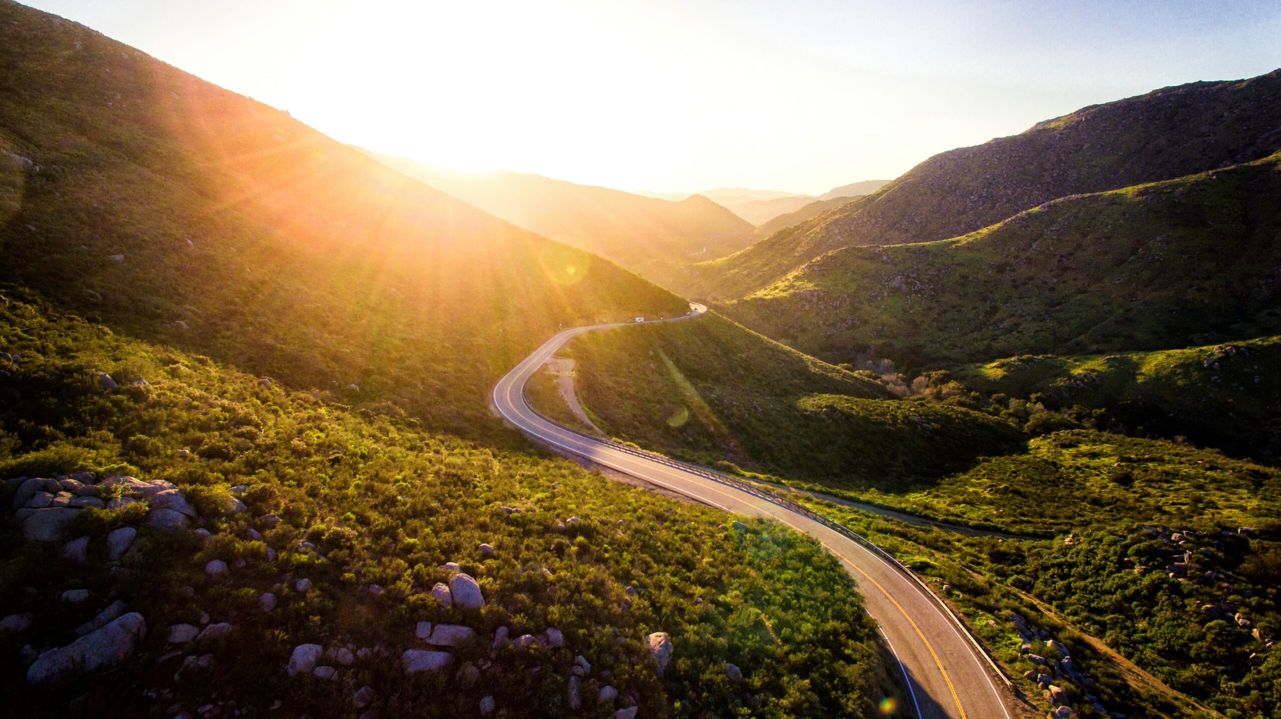 photo of a road through a sunny valley