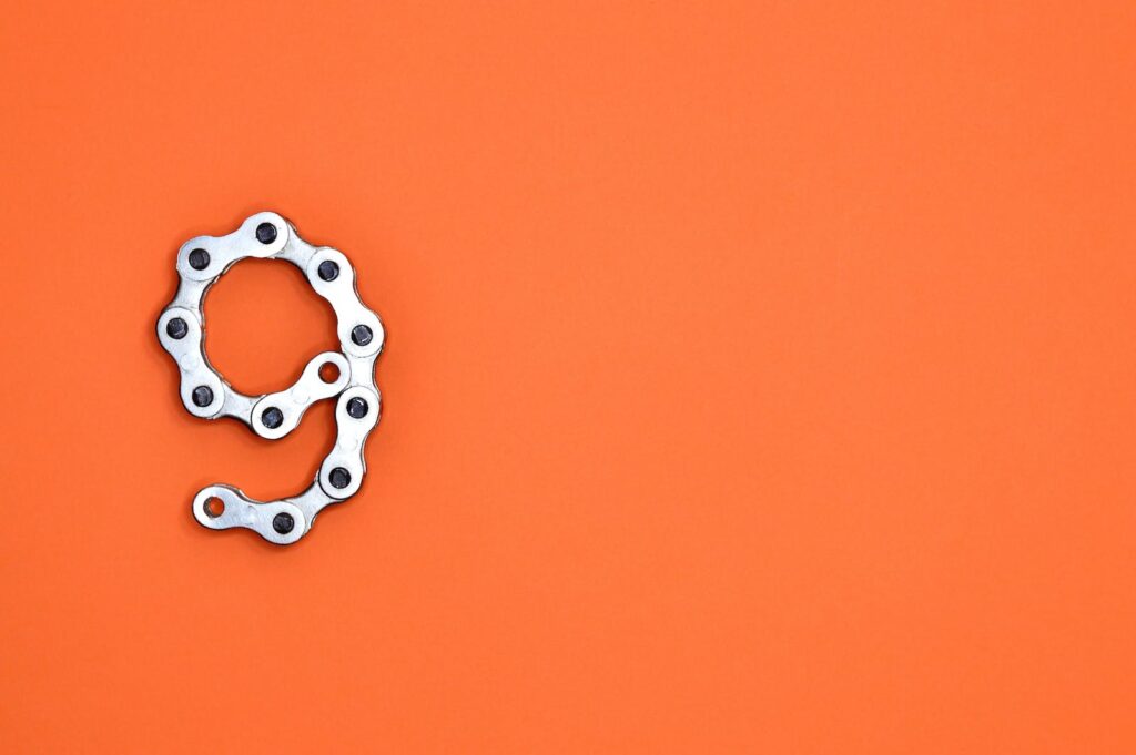 Gray Bicycle Chain on Orange Surface