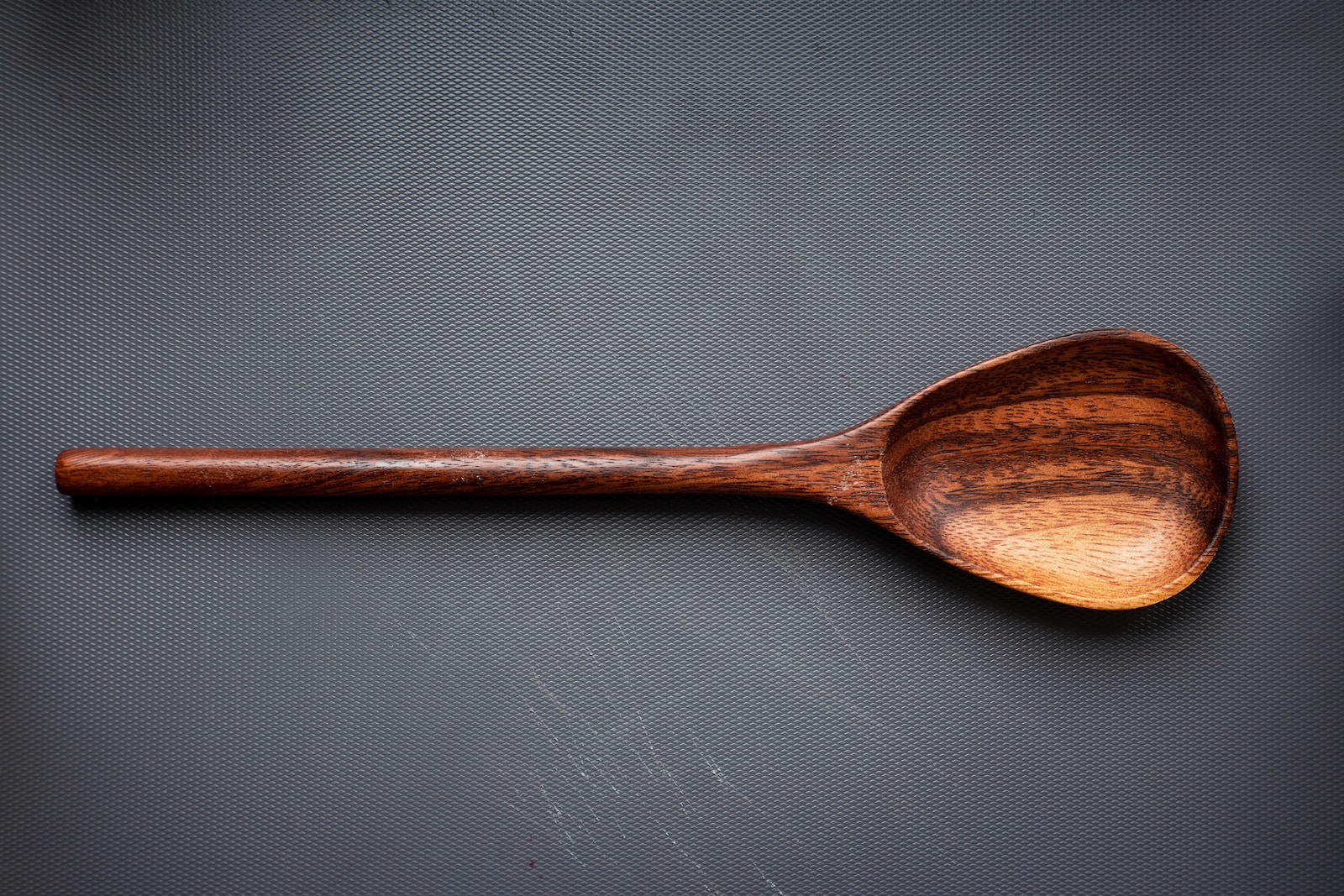 brown wooden spoon on white surface